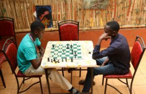 Roy (left) plays chess in college.